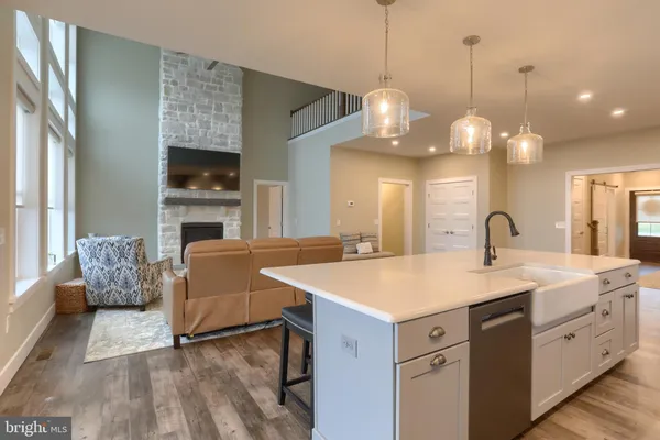 a open kitchen with stainless steel appliances granite countertop a sink a stove and a wooden floors