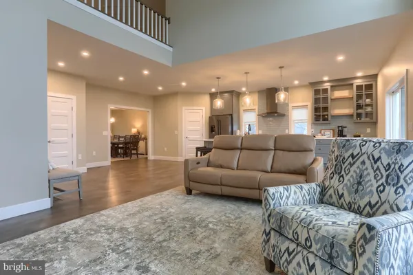 a living room with furniture and a dining table with kitchen view