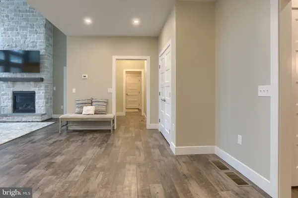 a view of a livingroom with wooden floor and a fireplace