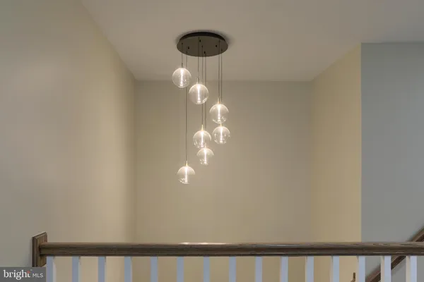 a view of a chandelier fan and window