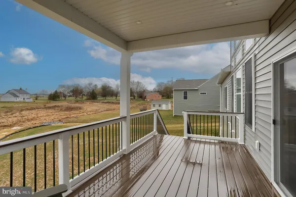 a view of balcony with wooden floor