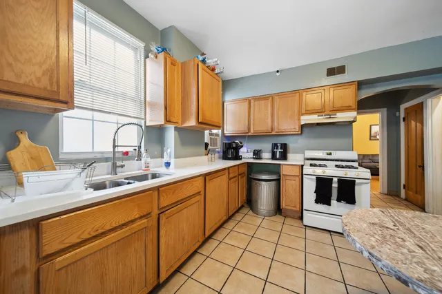 a kitchen with a white cabinets and white appliances