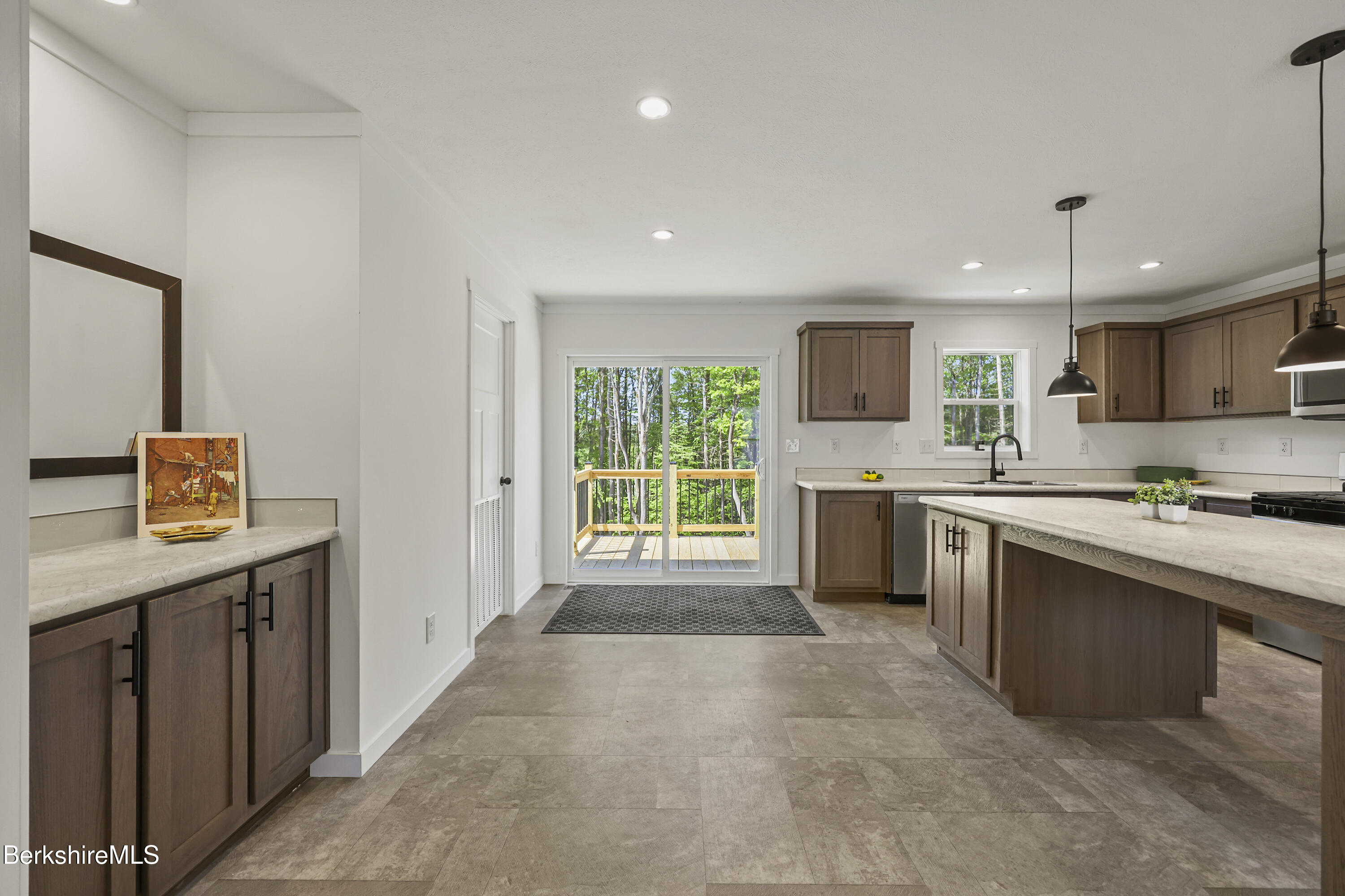 395 Cheshire Road, Unit 112 Pittsfield, MA 01201 - Photo 16 of 32 a large kitchen with stainless steel appliances granite countertop a stove a sink a refrigerator and a microwave