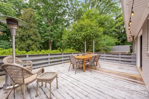 a view of a chairs and table on the wooden deck