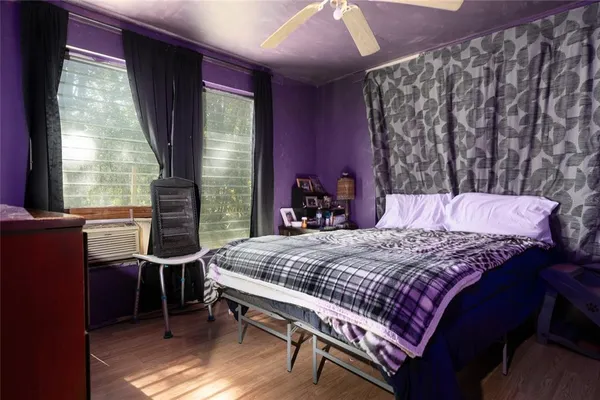 a bed sitting in a bedroom next to a lamp