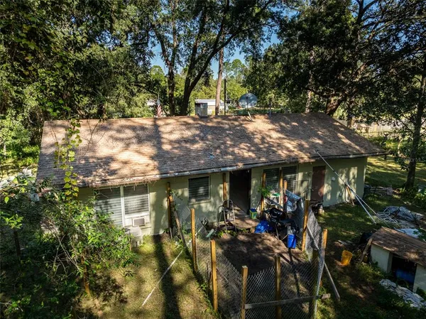a view of a house with a yard garage and sitting area