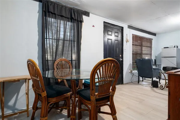 a bedroom with a bed table chair and a window