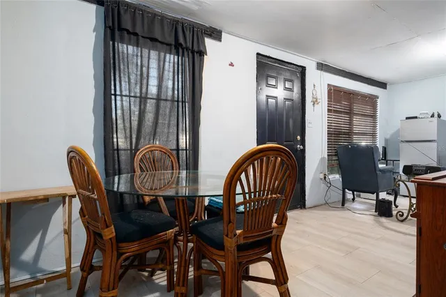a bedroom with a bed table chair and a window