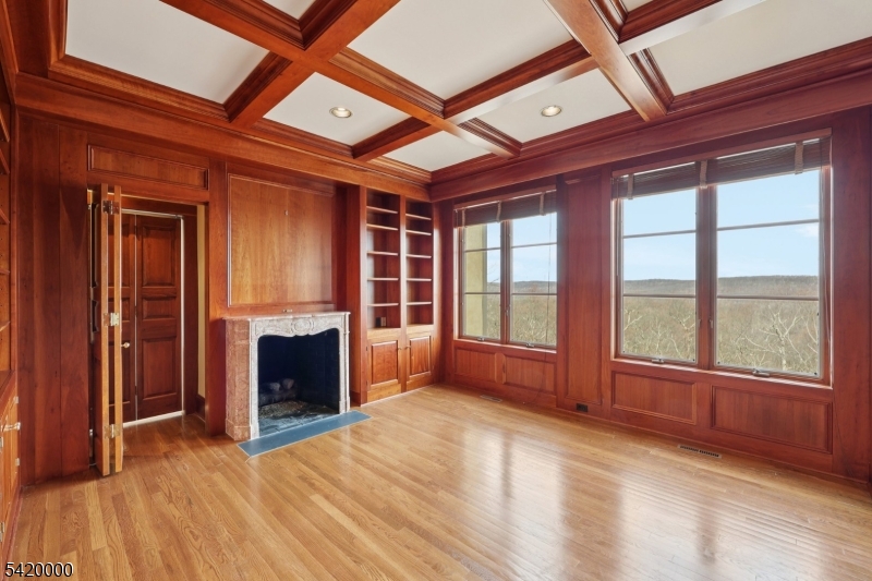 29 Hilltop Road Kinnelon, NJ 07405 - Photo 18 of 50 a view of an empty room with a fireplace and a window