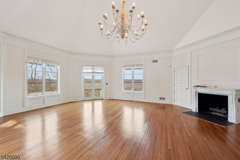 29 Hilltop Road Kinnelon, NJ 07405 - Photo 19 of 50 a view of an empty room with wooden floor and a window