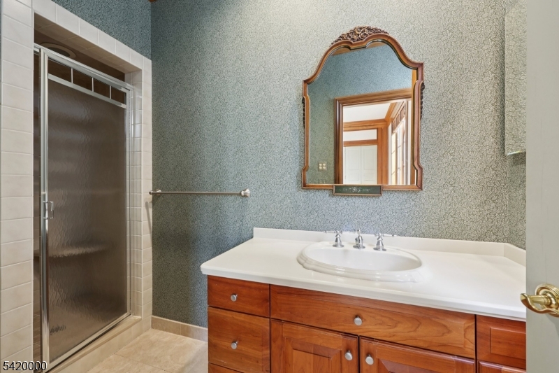 29 Hilltop Road Kinnelon, NJ 07405 - Photo 26 of 50 a bathroom with a sink and a mirror
