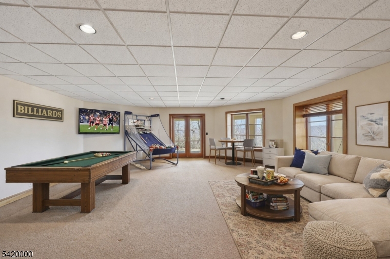 29 Hilltop Road Kinnelon, NJ 07405 - Photo 34 of 50 a living room with furniture gym equipment and a large window