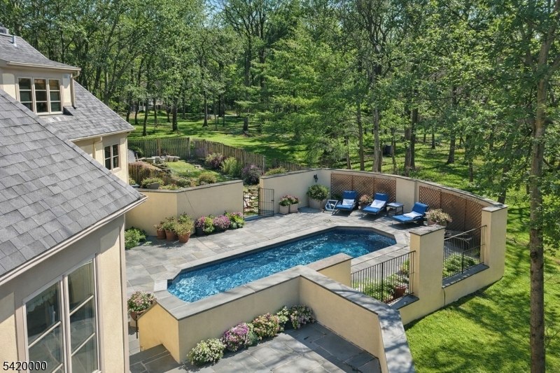29 Hilltop Road Kinnelon, NJ 07405 - Photo 42 of 50 a view of backyard with seating space and trees in the background