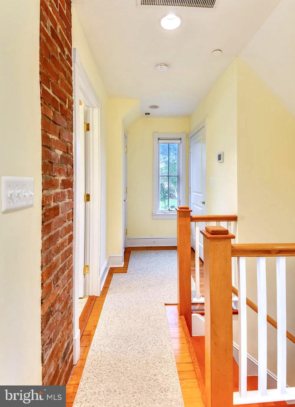 1212 Hayes Road Shady Side, MD 20764 - Photo 29 of 45 Upper Level Landing with Exposed Brick
