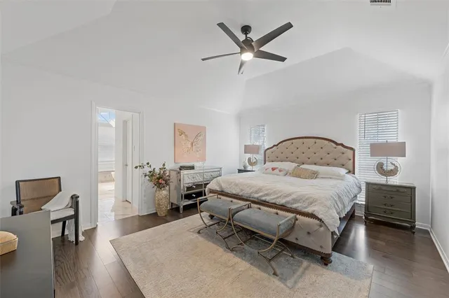 a bedroom with a bed a table and chair