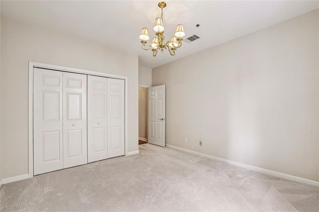 2499 Peachtree Street Northeast, Unit 406 Atlanta, GA 30305 - Photo 19 of 28 a view of an empty room with a chandelier
