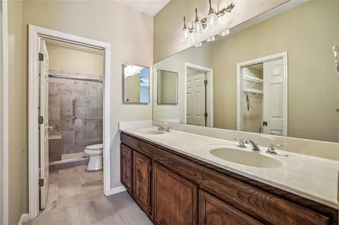 a spacious bathroom with a granite countertop sink toilet and shower