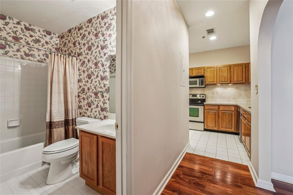 2499 Peachtree Street Northeast, Unit 406 Atlanta, GA 30305 - Photo 22 of 28 a bathroom with a toilet and a shower