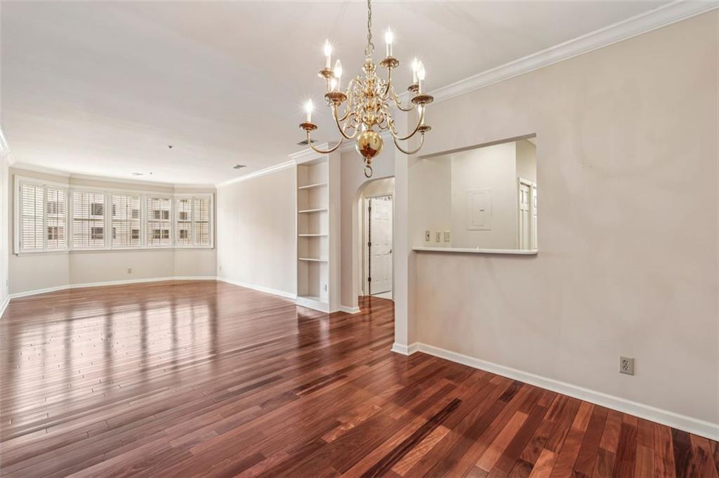 2499 Peachtree Street Northeast, Unit 406 Atlanta, GA 30305 - Photo 4 of 28 a view of an empty room with wooden floor and a window