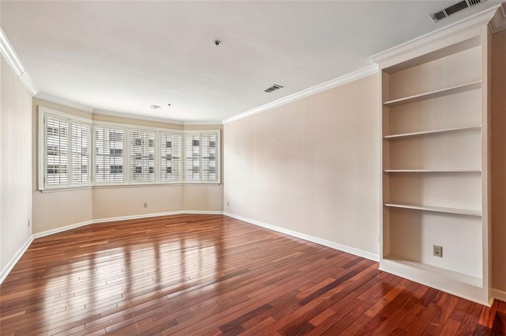 2499 Peachtree Street Northeast, Unit 406 Atlanta, GA 30305 - Photo 8 of 28 a view of an empty room with wooden floor and a window