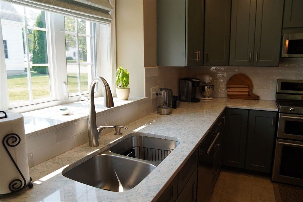 7 Turtle Hill Road, Unit B Ayer, MA 01432 - Photo 17 of 42 a kitchen with a sink and a stove next to a window