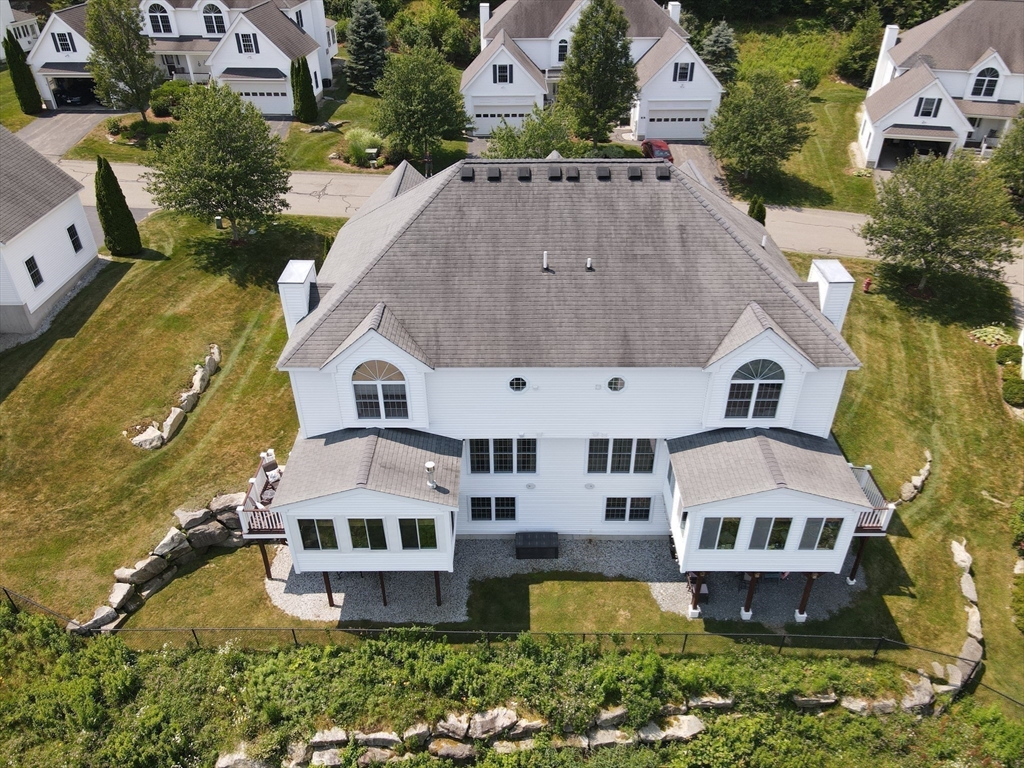 7 Turtle Hill Road, Unit B Ayer, MA 01432 - Photo 23 of 42 an aerial view of a house with a big yard and large trees
