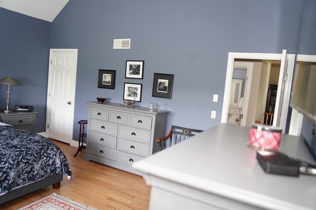 7 Turtle Hill Road, Unit B Ayer, MA 01432 - Photo 29 of 42 a bedroom with a bed and a dresser in it