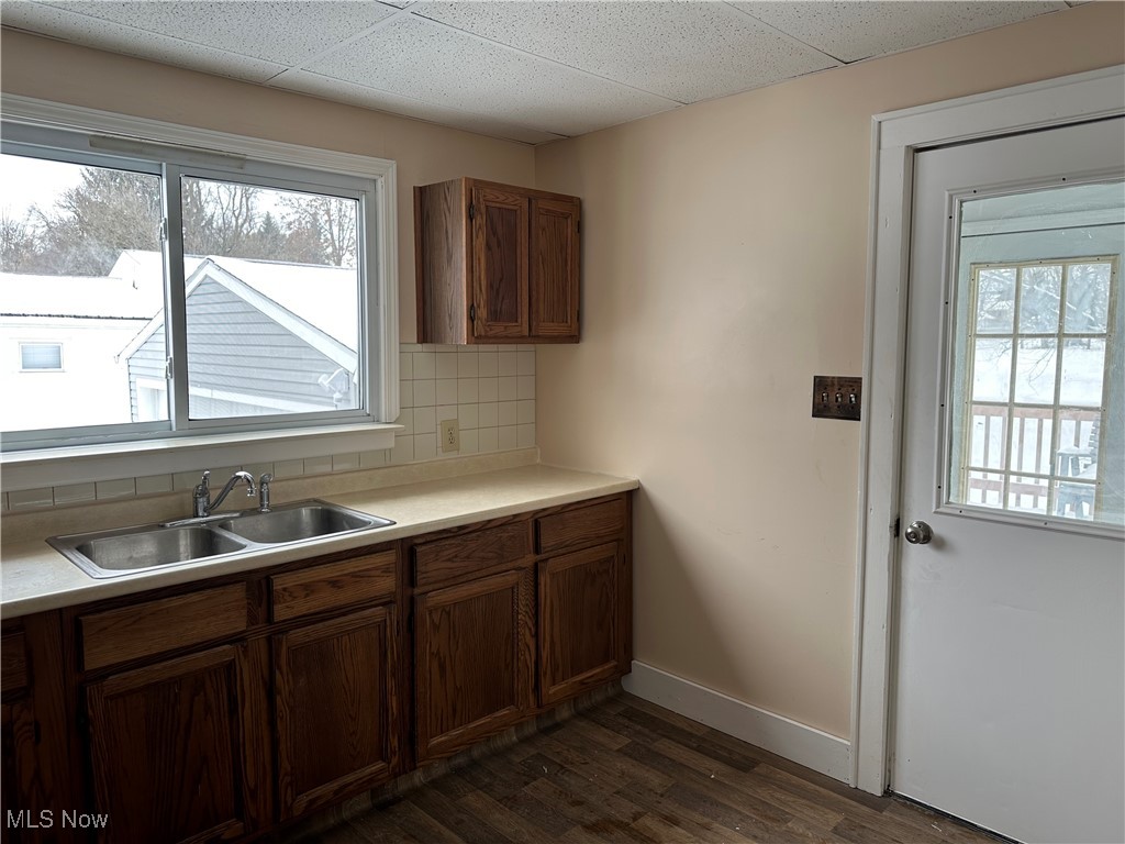 60 Taylor Road Barberton, OH 44203 - Photo 6 of 35 Kitchen with backsplash, dark wood-type flooring, sink, and a drop ceiling
