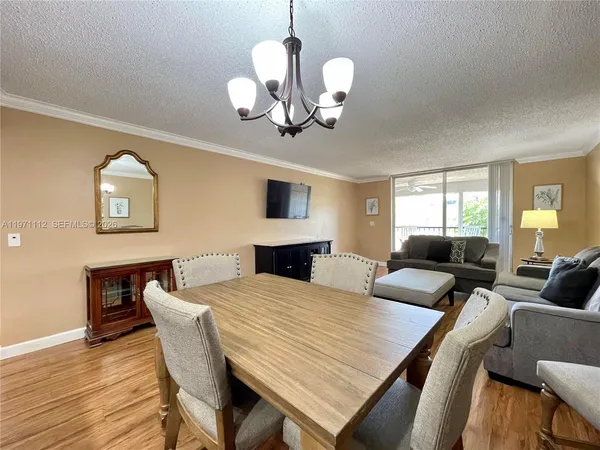 a view of a dining room with furniture and wooden floor