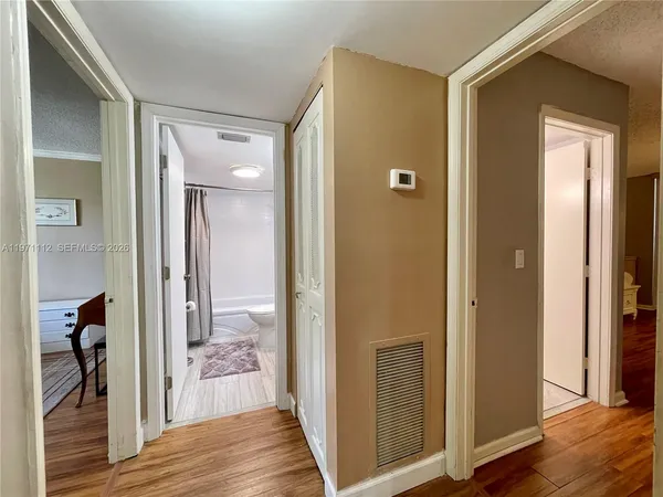 a view of a bathroom from a hallway