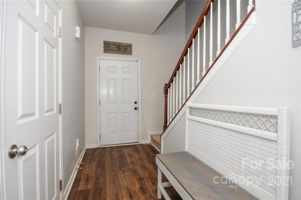 9907 Paper Tree Road Charlotte, NC 28227 - Photo 3 of 25 a view of a hallway with wooden floor and staircase