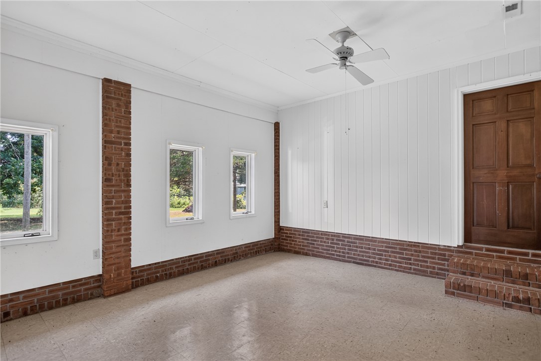 1412 Simpson Road Pendleton, SC 29670 - Photo 15 of 48 A well-lit, versatile room with a ceiling fan, offering bright views through multiple windows.