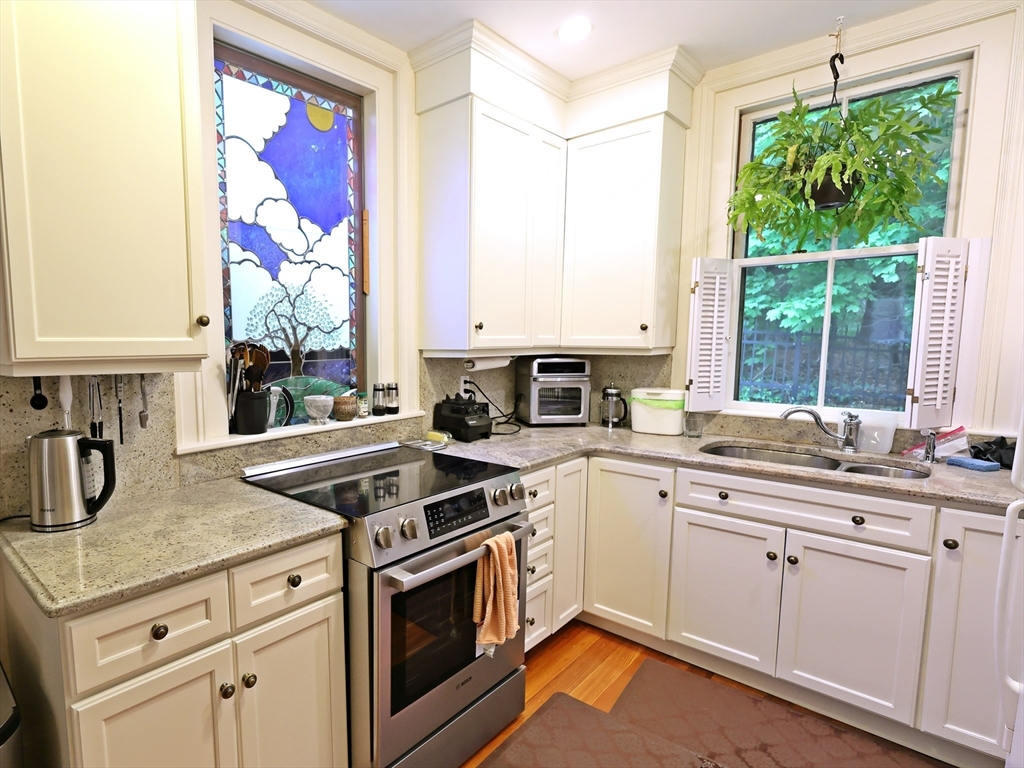a kitchen with appliances cabinets and a large window