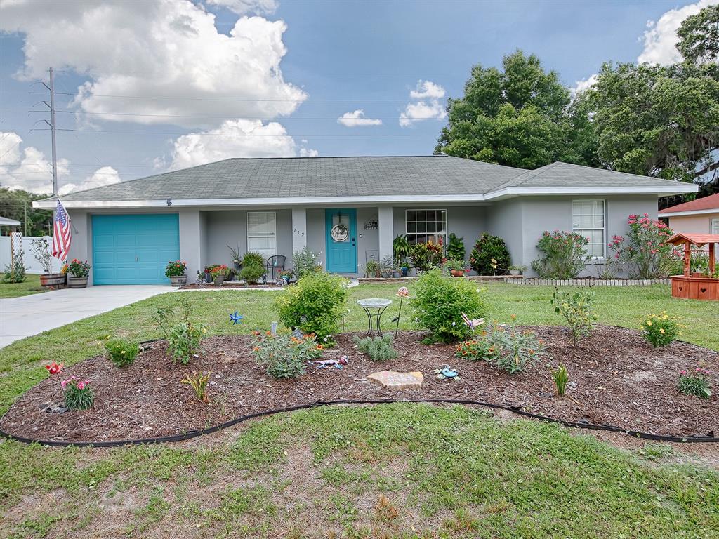 719 Boitnott Lane Bushnell, FL 33513 - Photo 1 of 1 a front view of a house with a yard and potted plants