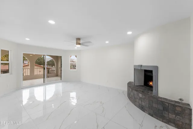 a view of an empty room with a fireplace