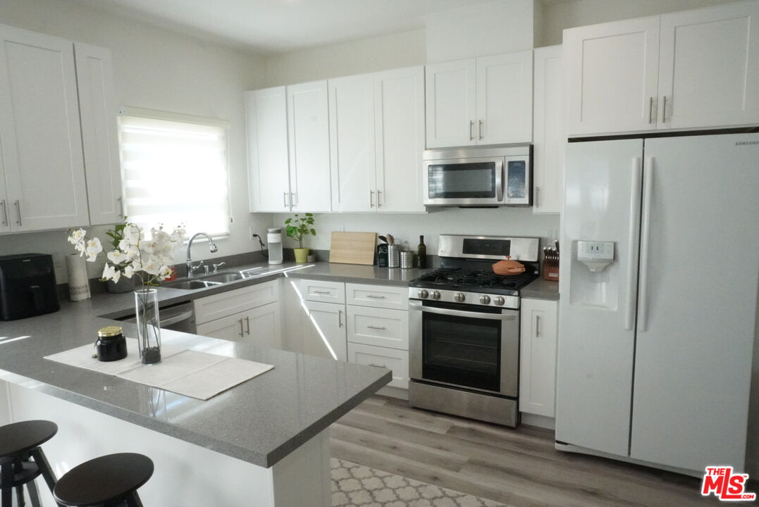 a kitchen with a sink a stove and cabinets