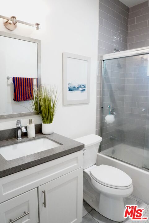1157 South Point View Street Los Angeles, CA 90035 - Photo 12 of 15 a bathroom with a sink a toilet and shower