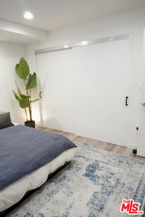1157 South Point View Street Los Angeles, CA 90035 - Photo 8 of 15 a bedroom with a bed and a potted plant