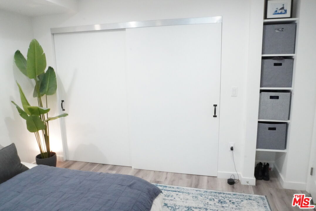 1157 South Point View Street Los Angeles, CA 90035 - Photo 9 of 15 a bedroom with a bed and a window