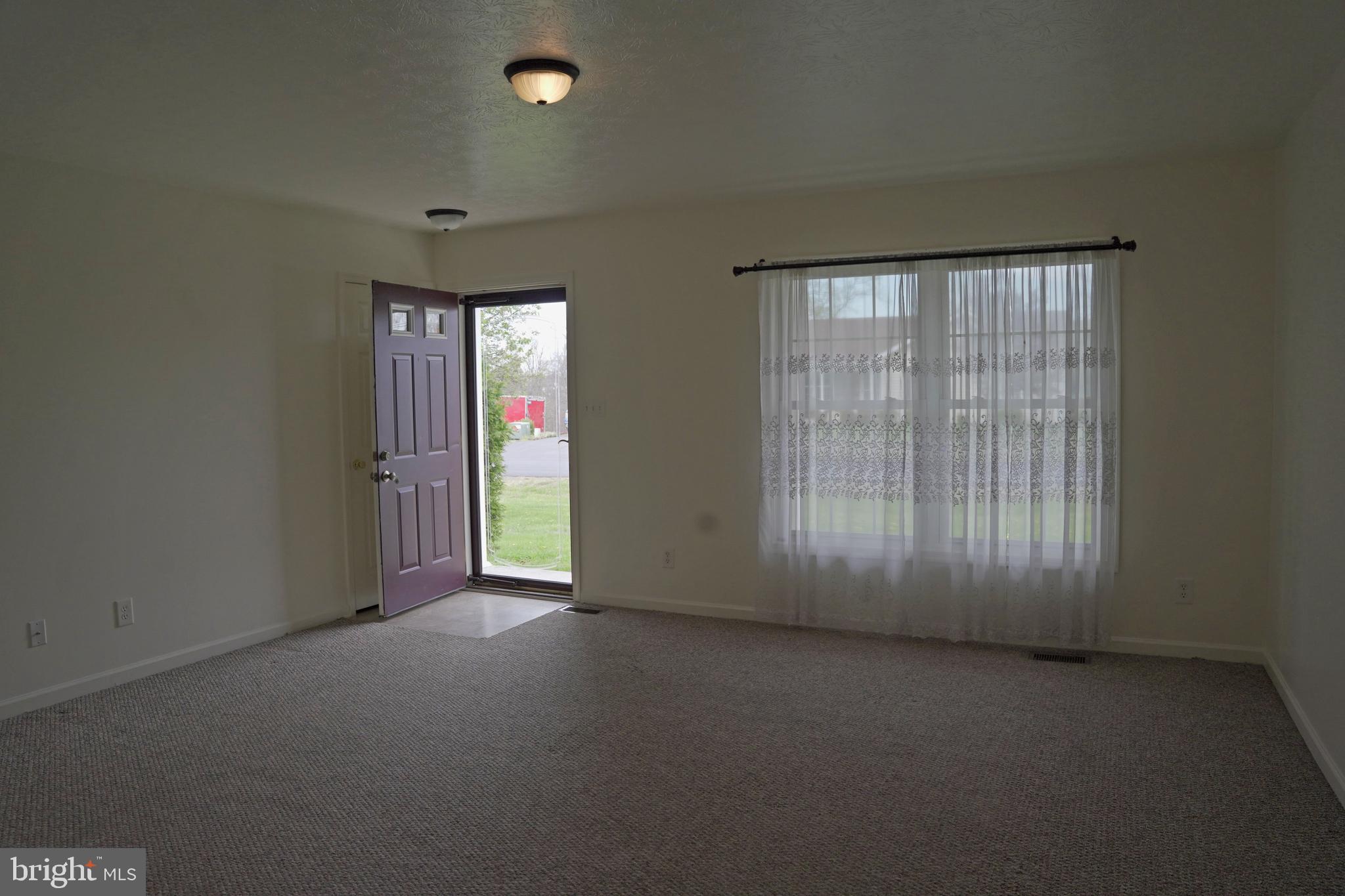 122 Sinker Drive Inwood, WV 25428 - Photo 2 of 28 an empty room with windows