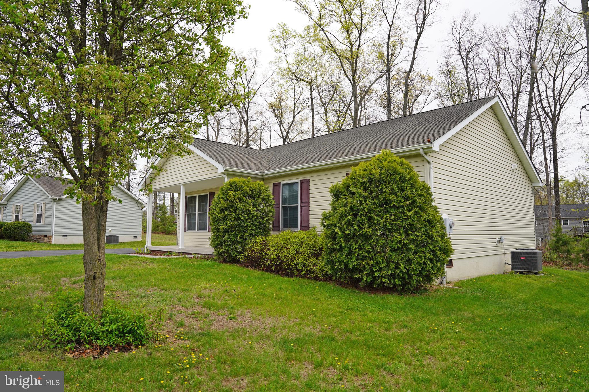 122 Sinker Drive Inwood, WV 25428 - Photo 22 of 28 a front view of a house with a garden