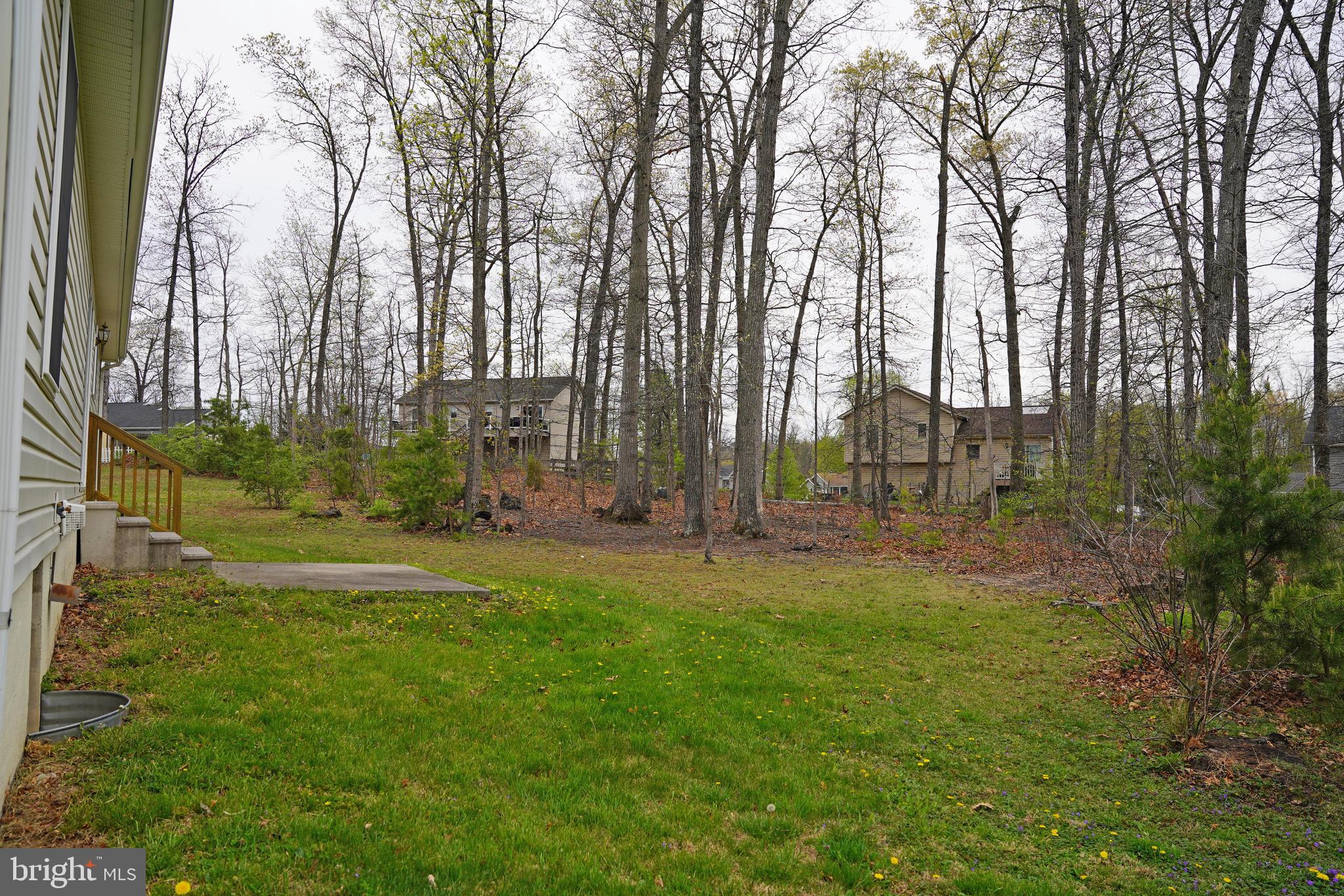 122 Sinker Drive Inwood, WV 25428 - Photo 23 of 28 a backyard of apartments with large trees