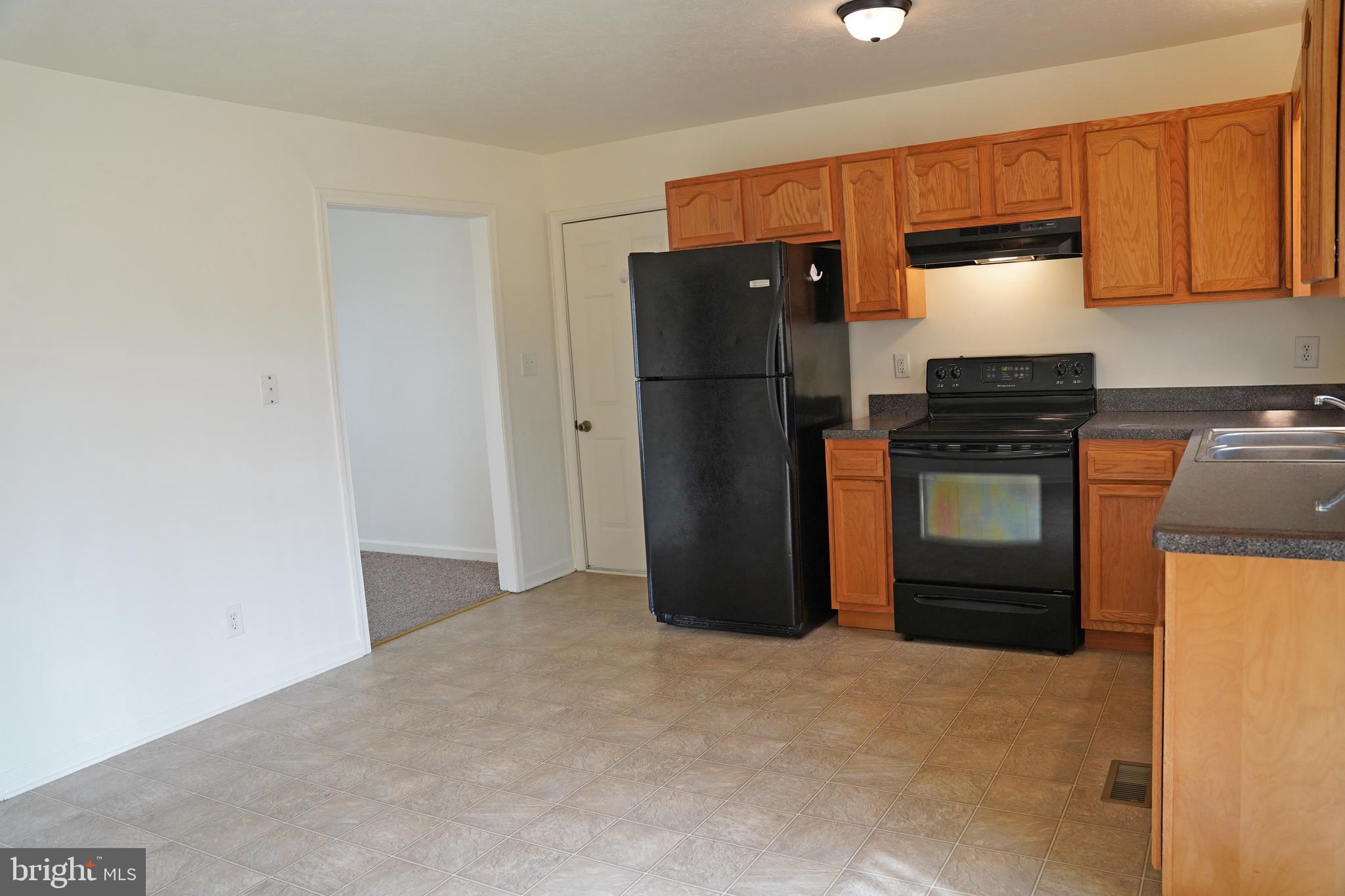 122 Sinker Drive Inwood, WV 25428 - Photo 7 of 28 a kitchen with a refrigerator and a stove