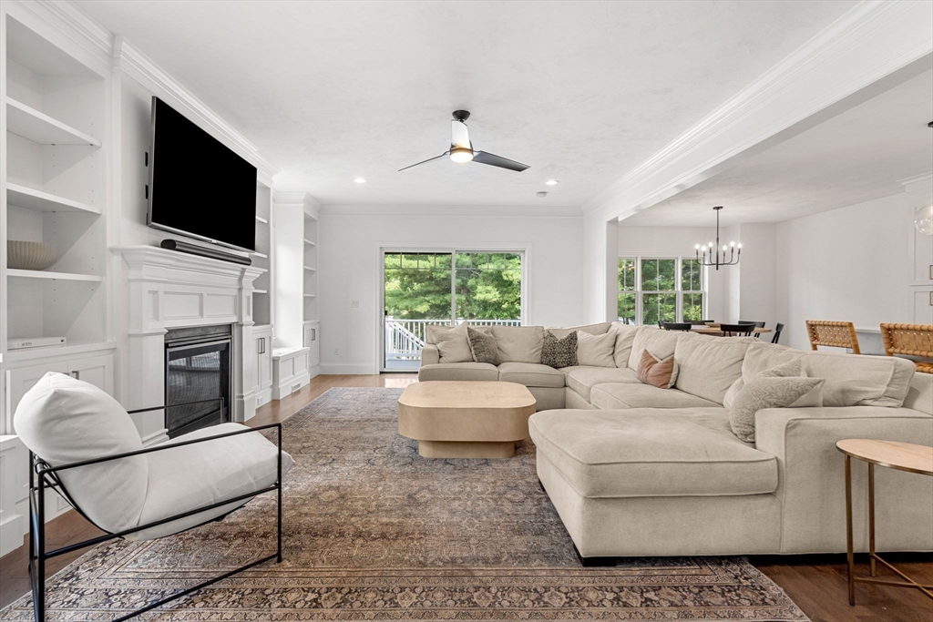 32 Cutter Lane, Unit 32 Amesbury, MA 01913 - Photo 11 of 37 a living room with fireplace furniture and a flat screen tv