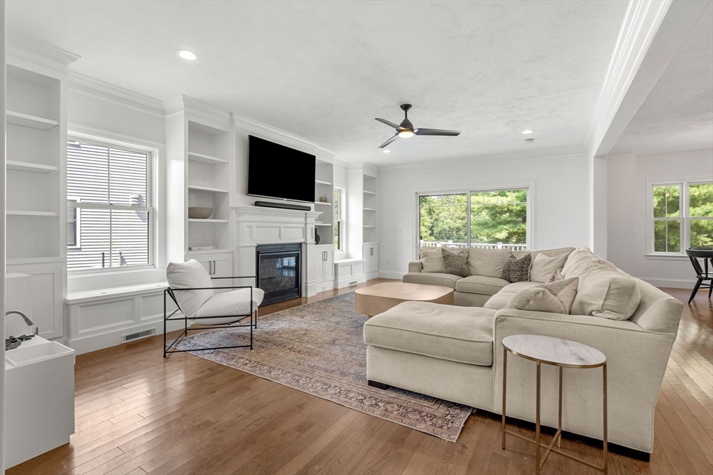 32 Cutter Lane, Unit 32 Amesbury, MA 01913 - Photo 12 of 37 a living room with furniture fireplace and a flat screen tv
