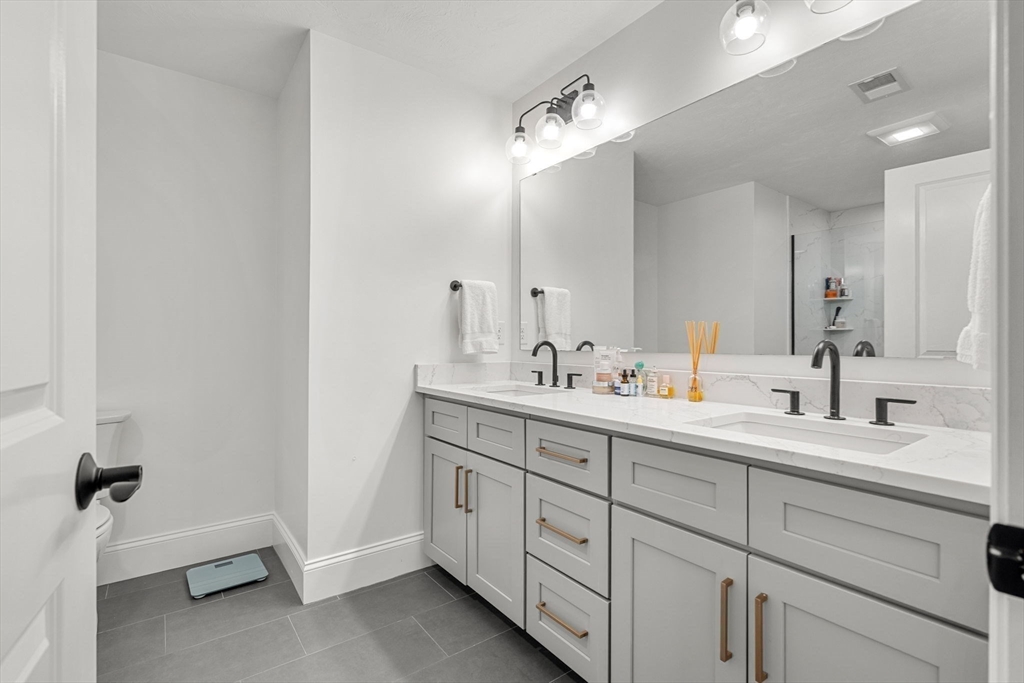 32 Cutter Lane, Unit 32 Amesbury, MA 01913 - Photo 18 of 37 a bathroom with a double vanity sink mirror and bathtub