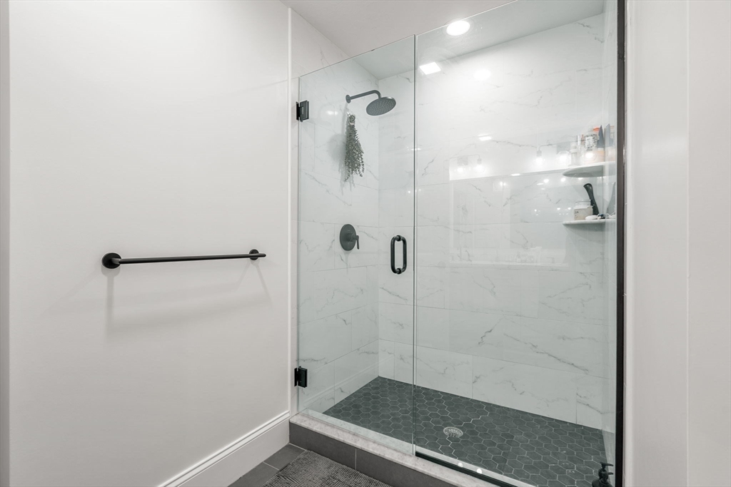 32 Cutter Lane, Unit 32 Amesbury, MA 01913 - Photo 19 of 37 a bathroom with a glass shower door