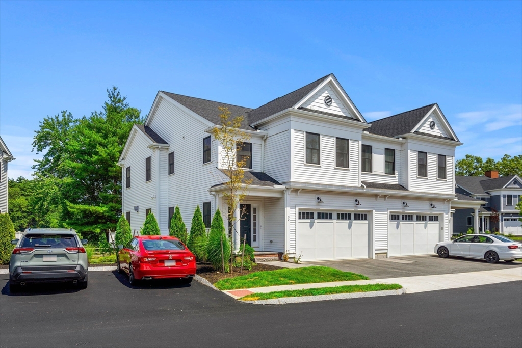 32 Cutter Lane, Unit 32 Amesbury, MA 01913 - Photo 31 of 37 a front view of a house with a garden and parking