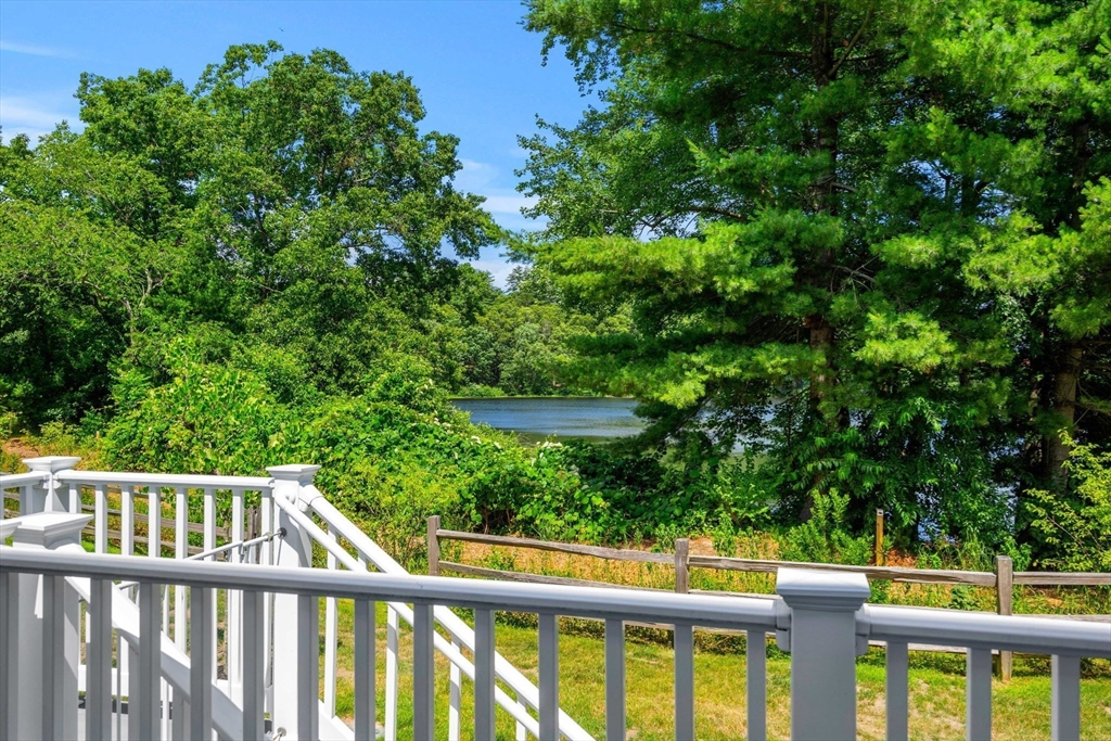 32 Cutter Lane, Unit 32 Amesbury, MA 01913 - Photo 36 of 37 a view of a wooden fence and trees