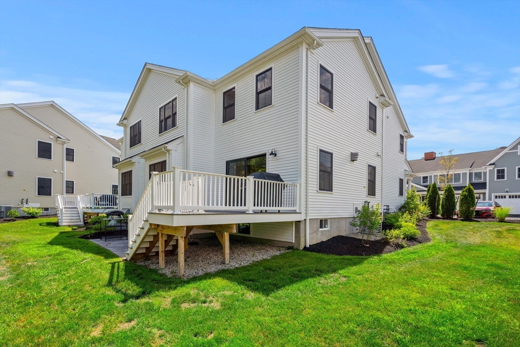32 Cutter Lane, Unit 32 Amesbury, MA 01913 - Photo 4 of 37 a view of a house with a yard and deck